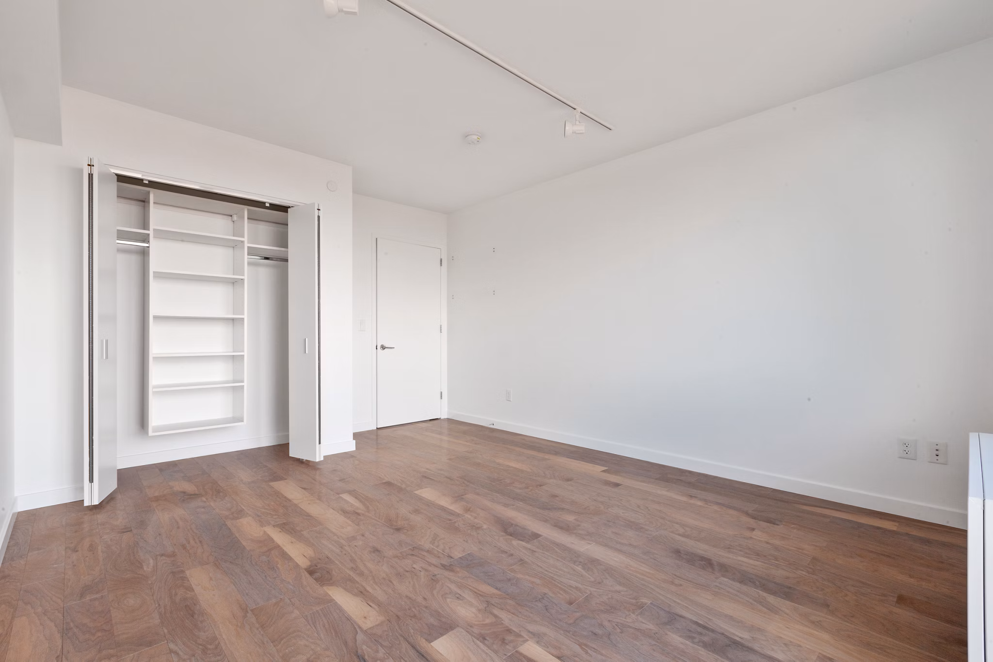 Modern bedroom with expansive windows at 461 Dean Apartments, offering luxury living in a sought-after location