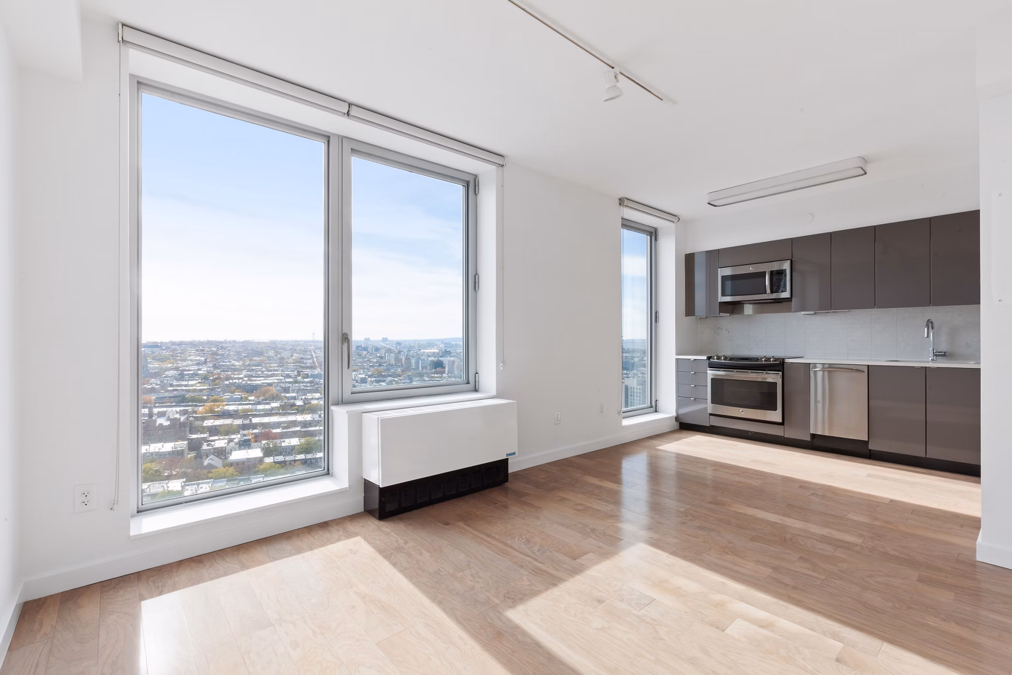 Open living room with modern furnishings and large windows in 461 Dean Apartments