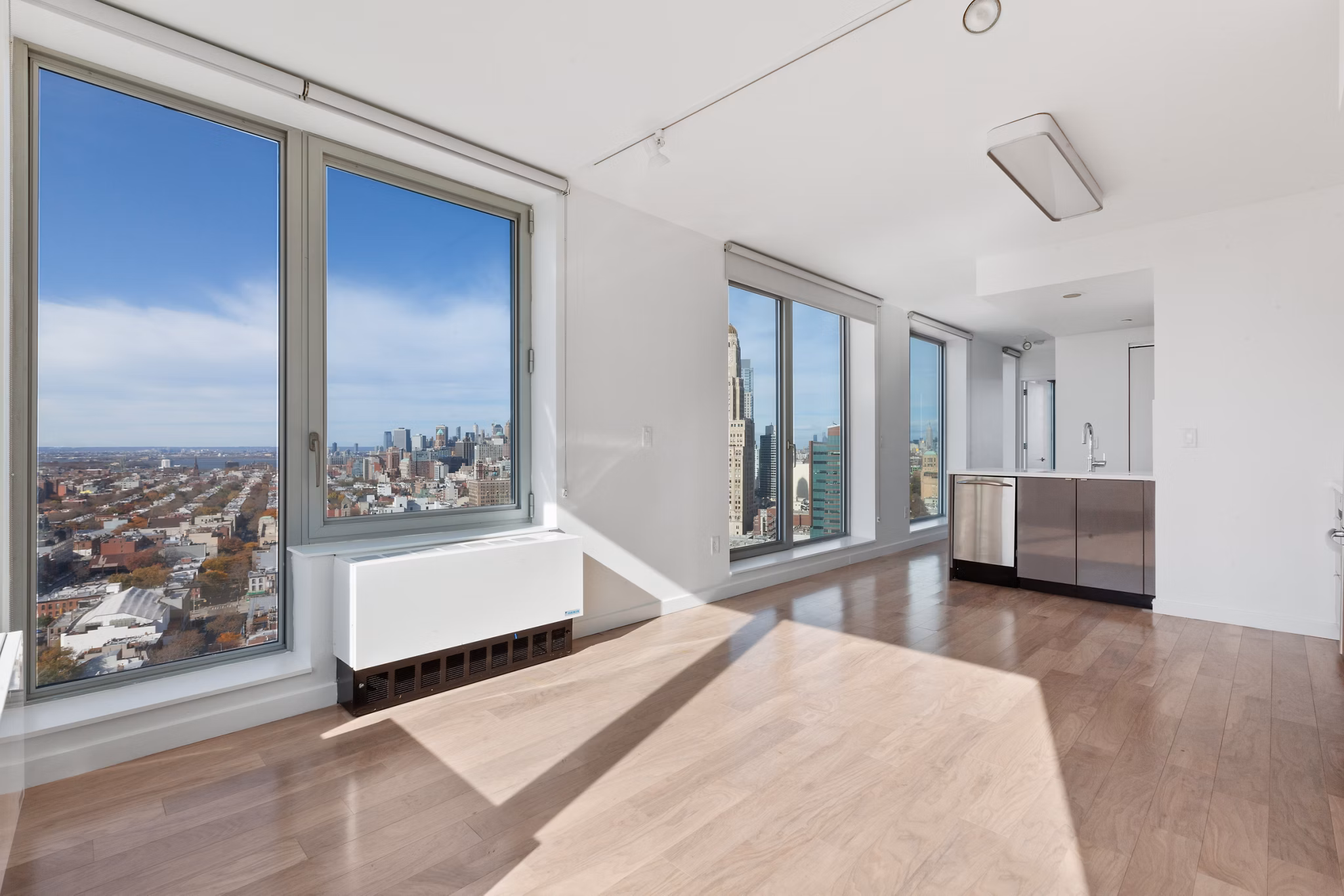 Spacious apartment with large windows and cityscape views in luxury apartment community
