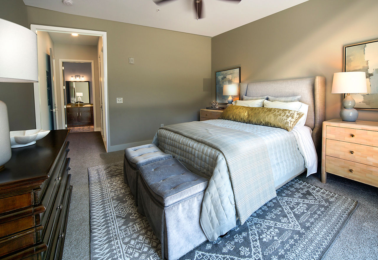 Cozy bedroom with modern furnishings at WaterWalk at Shelter Cove Towne Centre