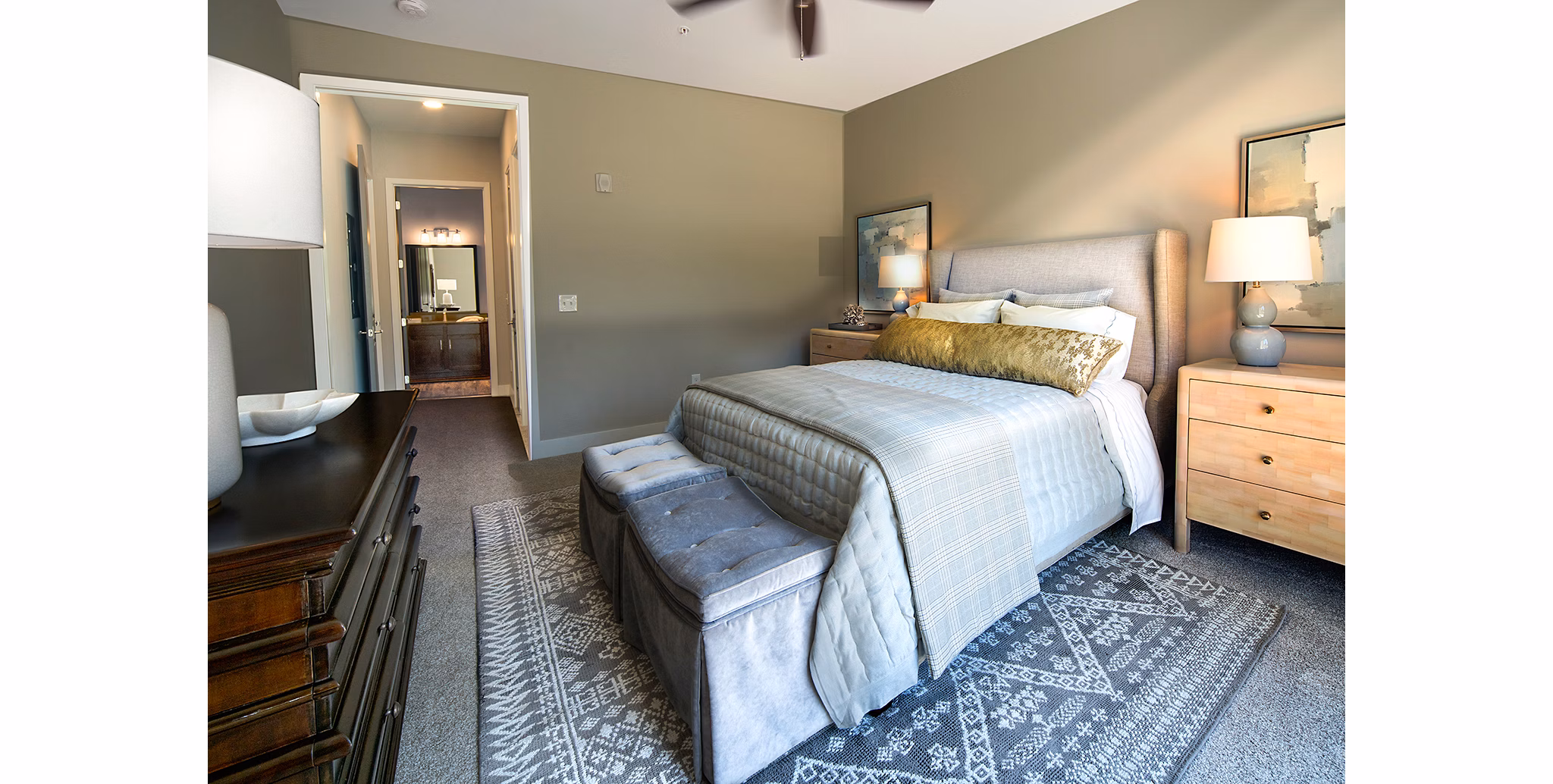 Cozy bedroom with modern furnishings at WaterWalk at Shelter Cove Towne Centre