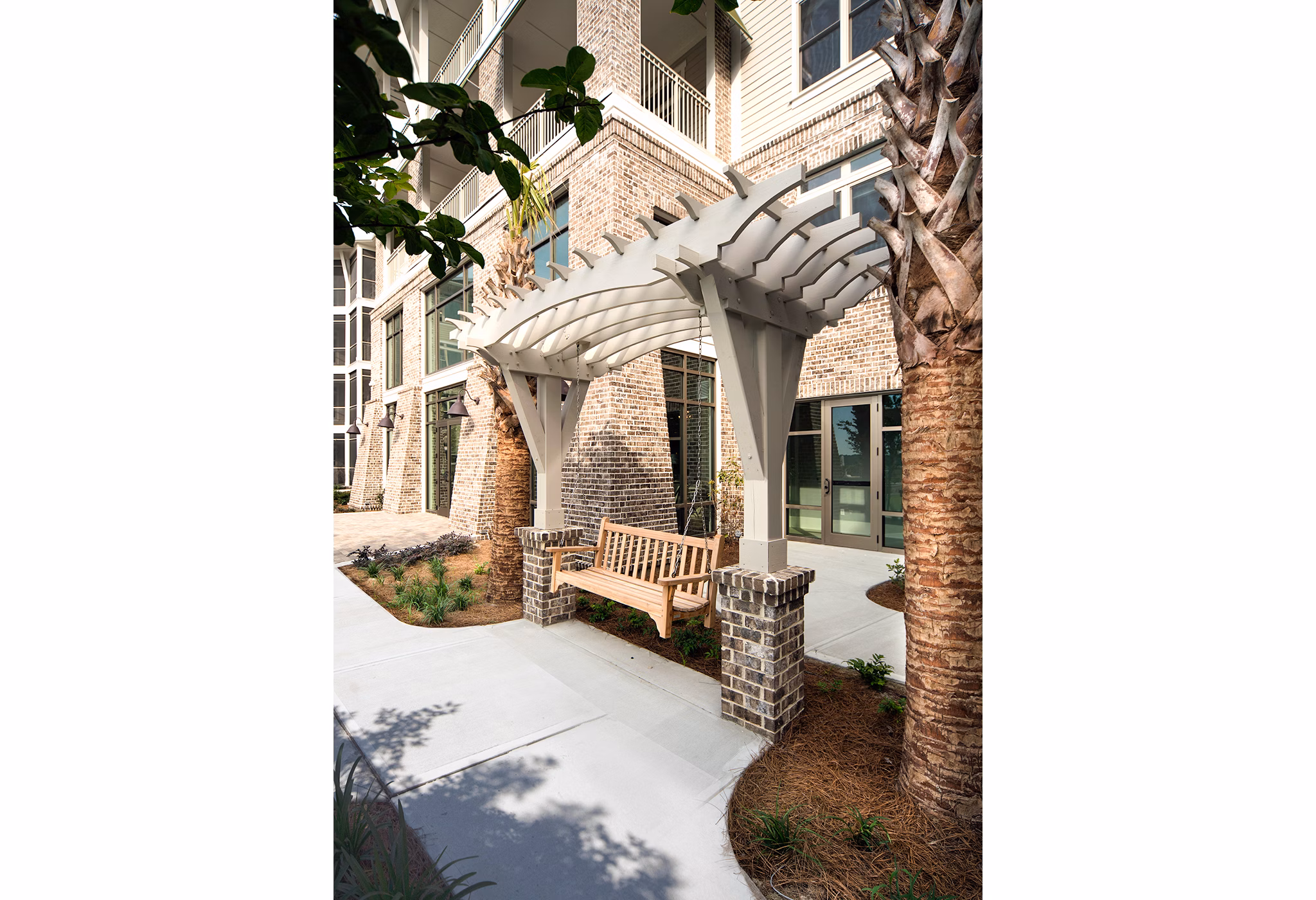 Tranquil courtyard with lush greenery at WaterWalk at Shelter Cove Towne Centre luxury apartments