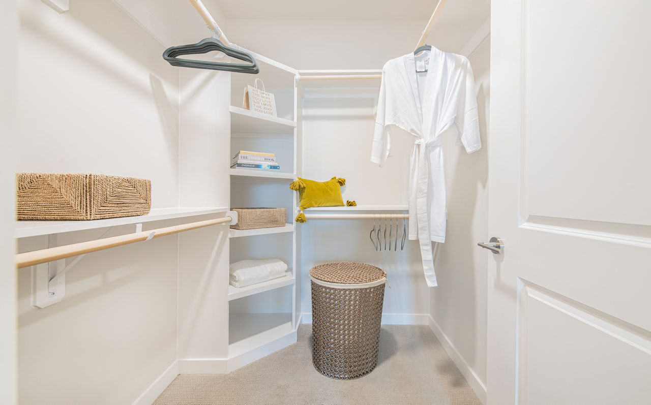 Walk-in closet with ample shelving at Overture Daniel Island Apartments, luxury living spaces