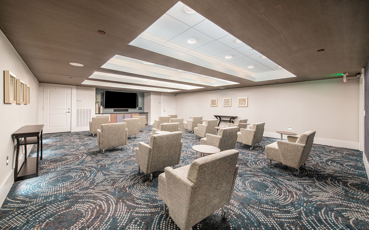 Theater room with plush seating at Overture Daniel Island Apartments