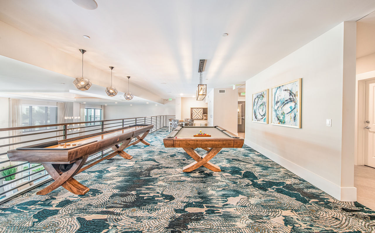 Game room featuring billiards and lounge seating at Overture Daniel Island Apartments, luxury living on Daniel Island