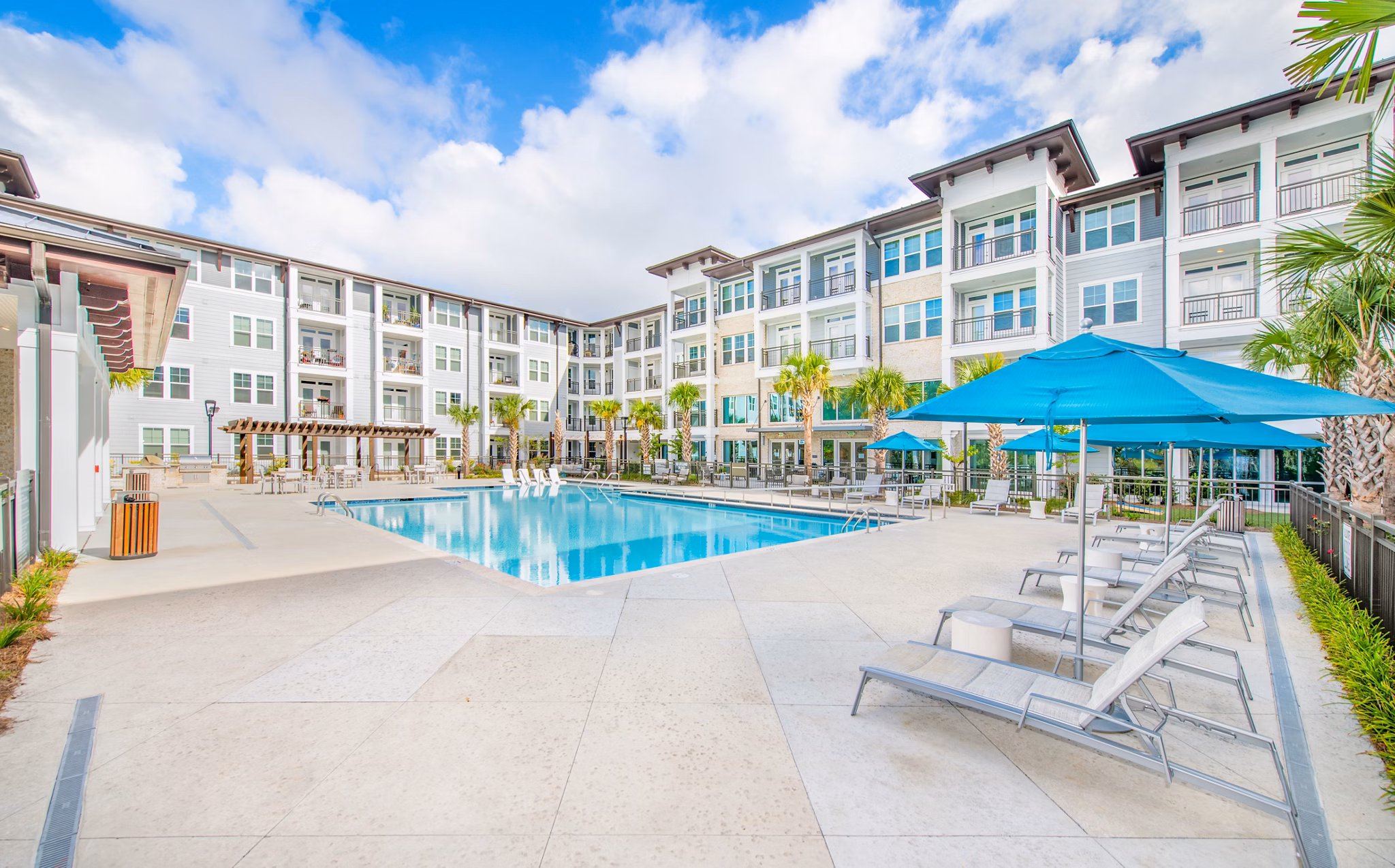 Rooftop infinity pool with sun loungers at Overture Daniel Island luxury apartments