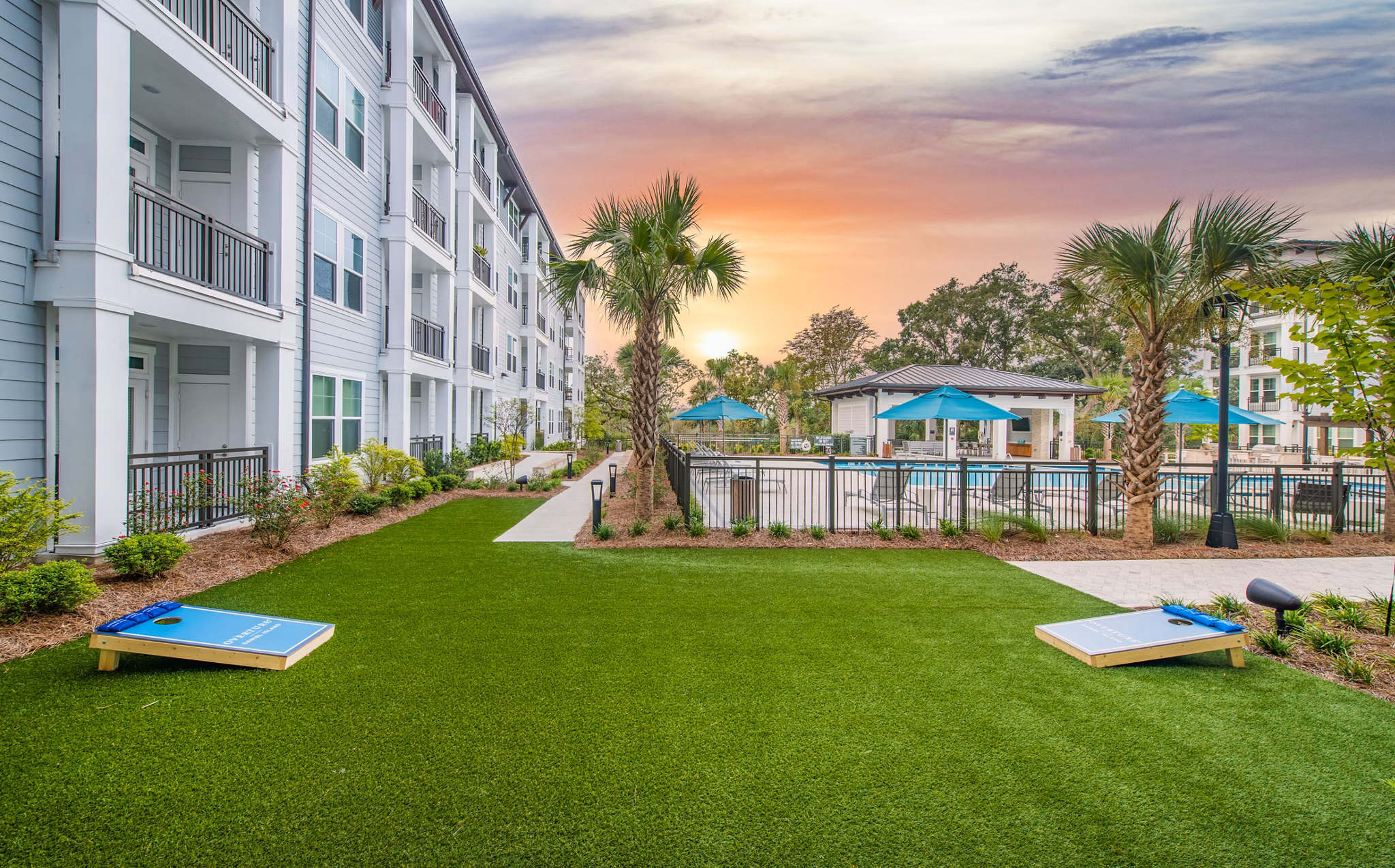 Courtyard featuring lush gardens and seating at Overture Daniel Island Apartments