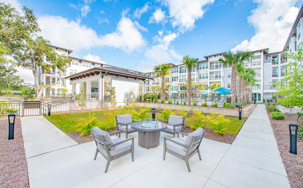Fire pit surrounded by cozy seating at Overture Daniel Island Apartments, perfect for outdoor relaxation and socializing