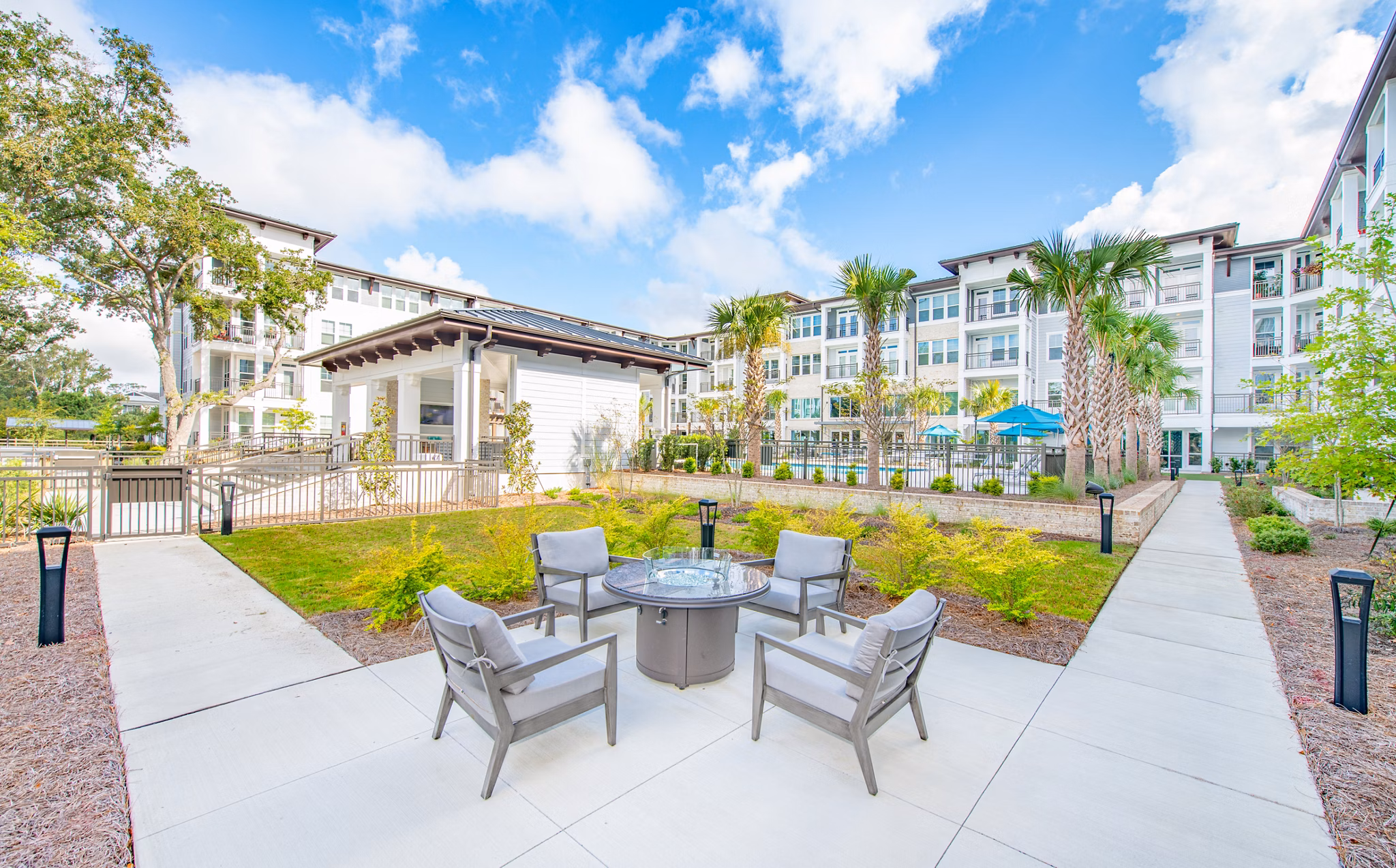 Fire pit surrounded by cozy seating at Overture Daniel Island Apartments, perfect for outdoor relaxation and socializing