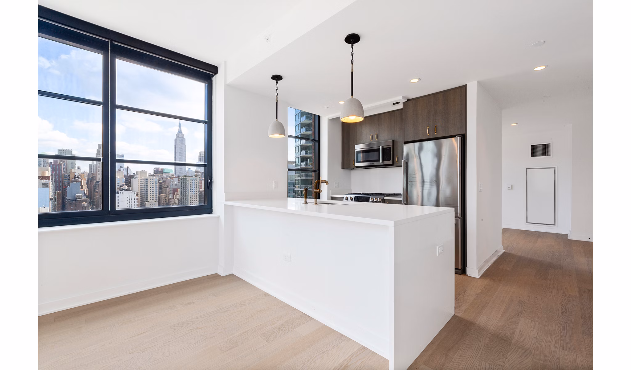 Modern kitchen with stainless steel appliances at Henry Hall Apartments, offering luxury living spaces