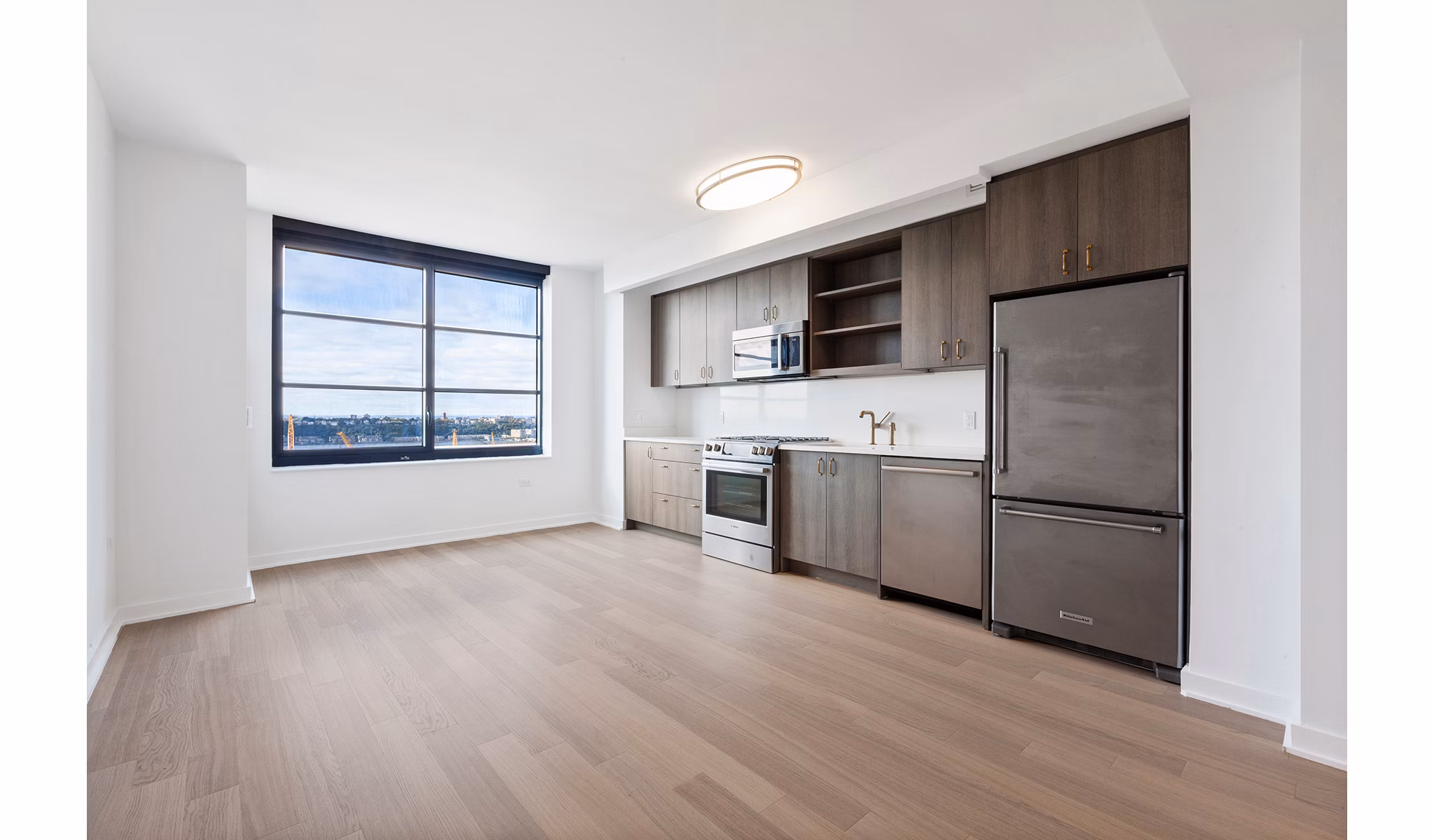 Modern kitchen with stainless steel appliances at Henry Hall Apartments available at Greystar Luxury Apartments