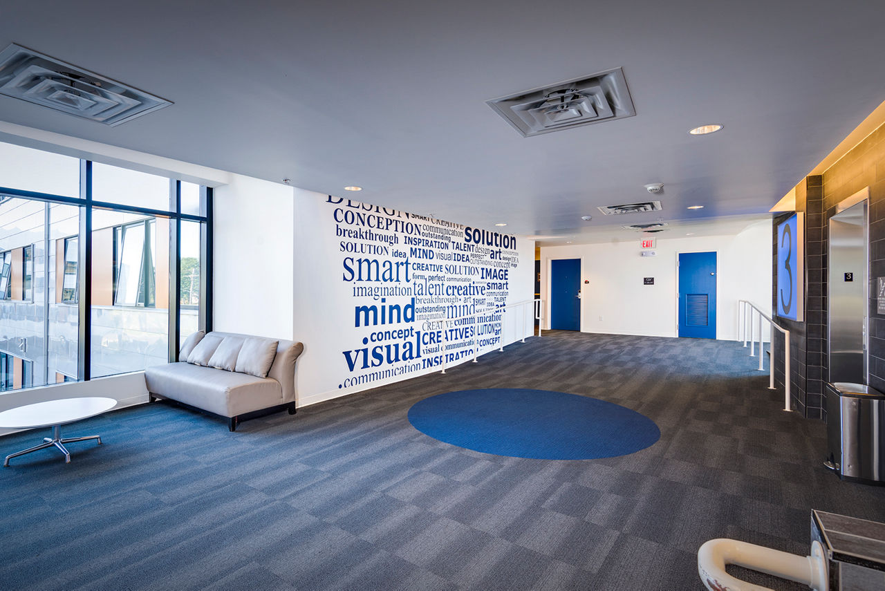 Campus West Apartments: Sleek hallways with modern elevators providing easy access on each floor, enhancing luxury living experience