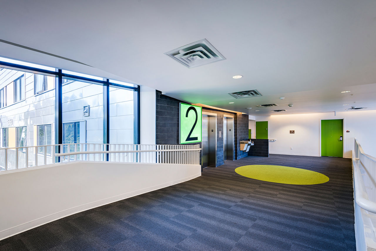 Campus West Apartments: Hallway with modern elevators, offering luxury living experience