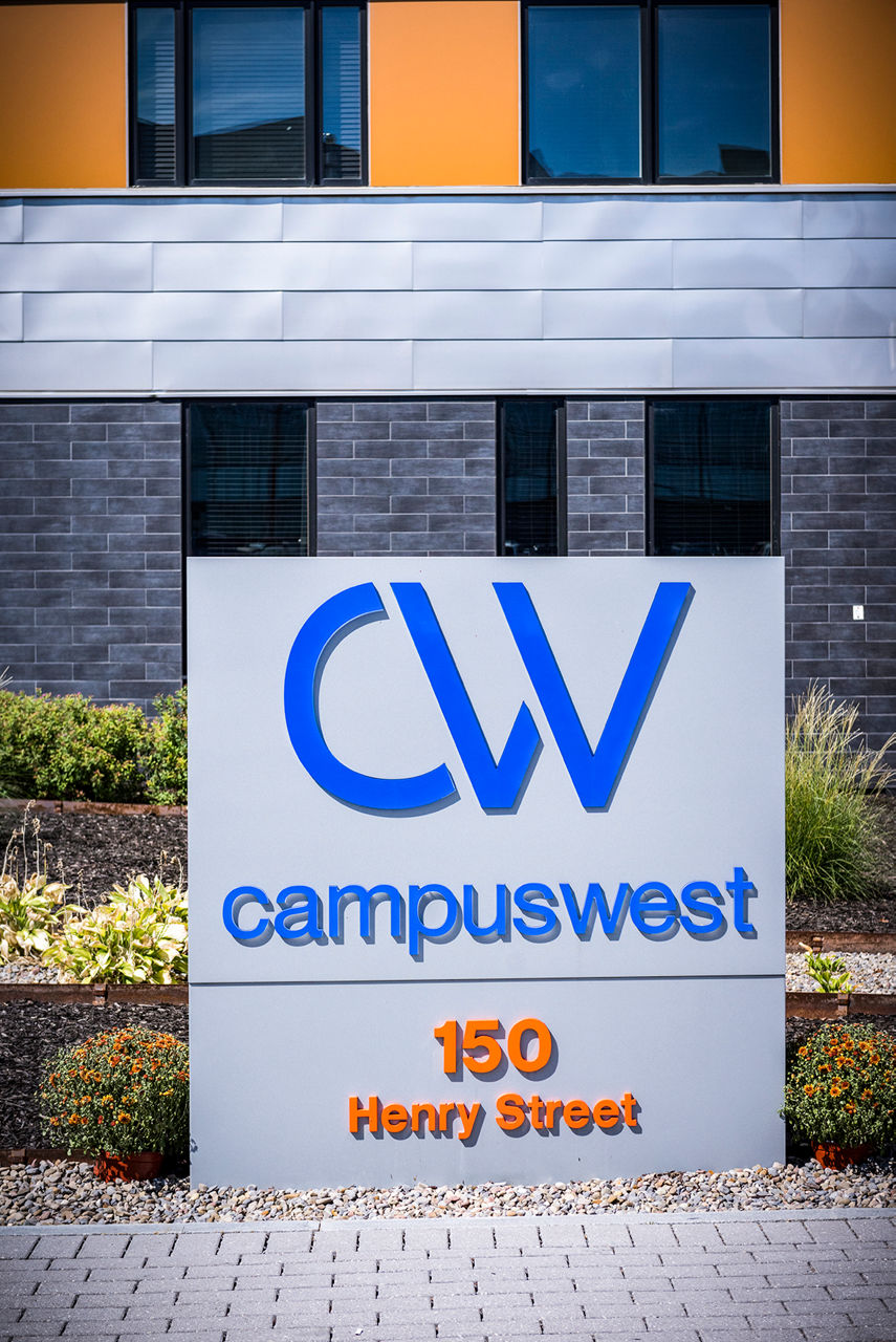 Campus West sign at 150 Henry Street, showcasing luxury apartments in a vibrant neighborhood