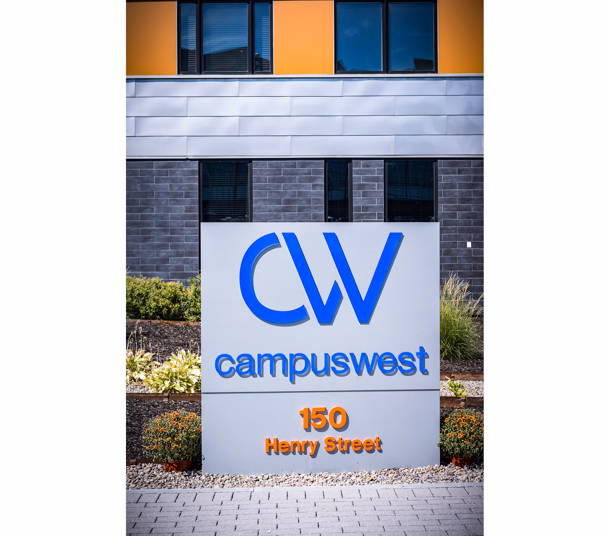 Campus West sign at 150 Henry Street, showcasing luxury apartments in a vibrant neighborhood