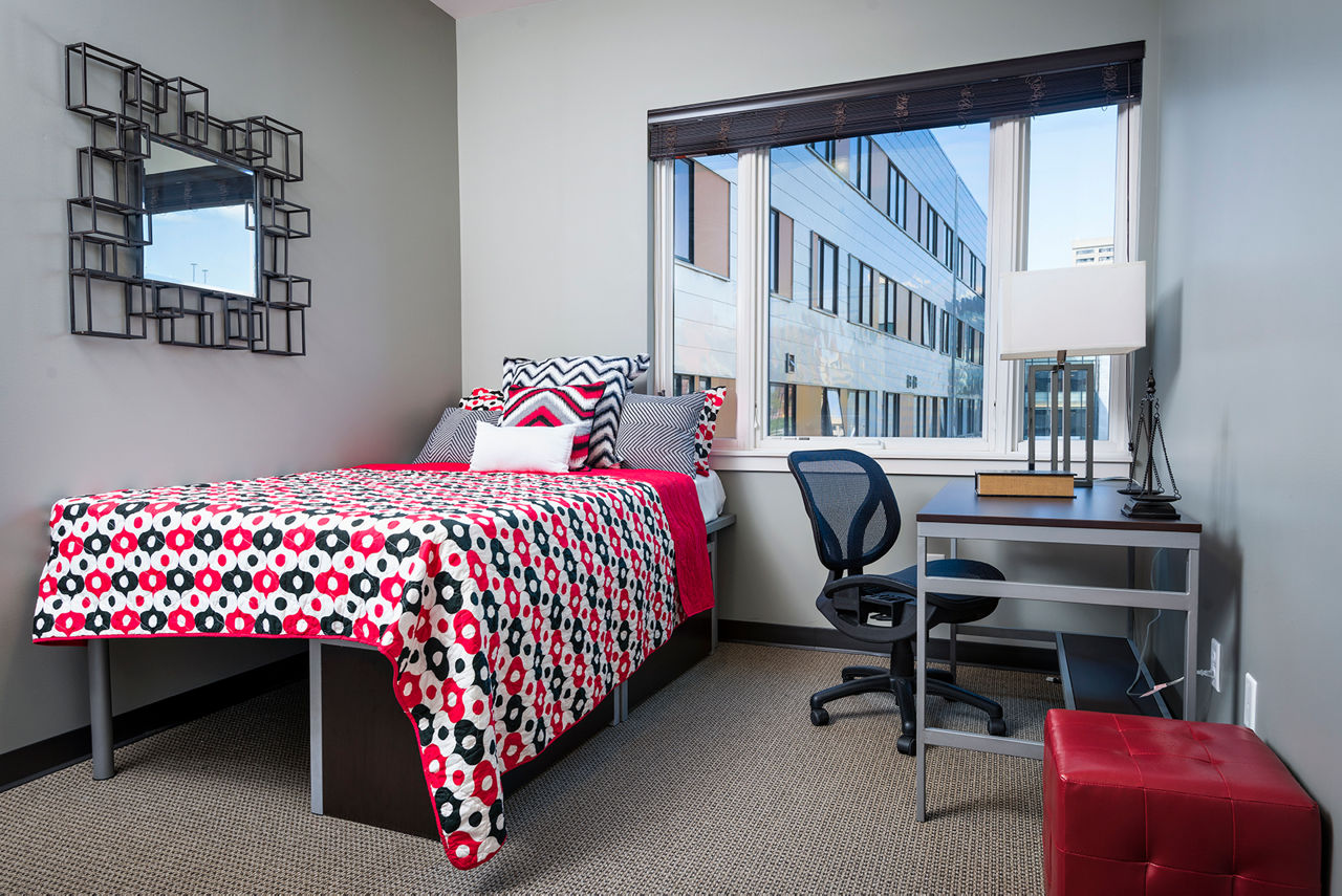 Modern bedroom with cozy decor at Campus West Apartments, ideal for student living near the university