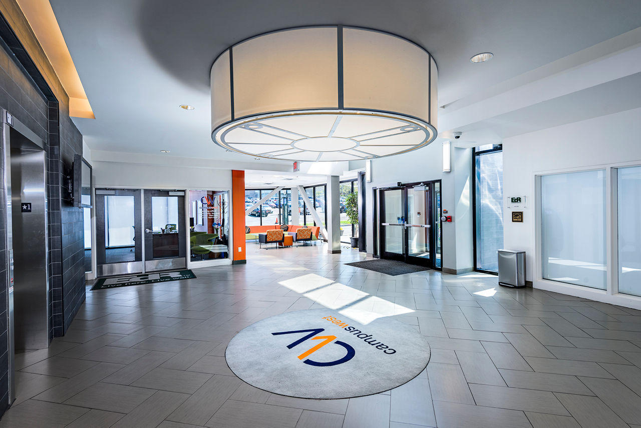 Campus West Apartments: Elegant clubhouse front lobby with elevators, showcasing luxury living