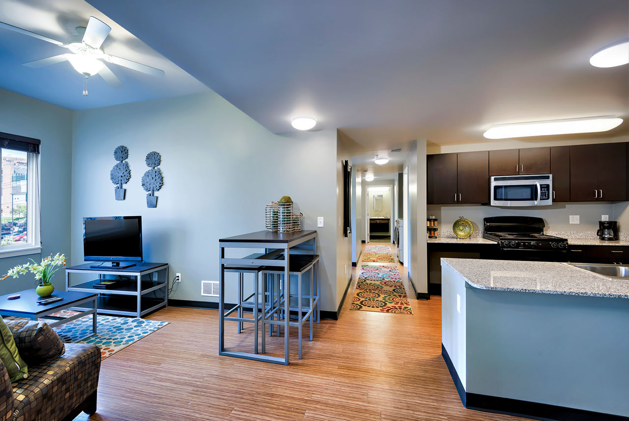 Dining room with modern furnishings and pendant lighting at Campus West Apartments Perfect for hosting dinners in style