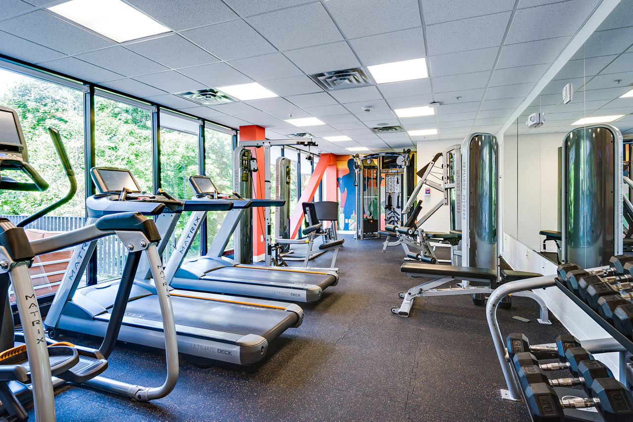 State-of-the-art fitness center with modern equipment at Campus West Apartments, offering luxurious amenities for a healthy lifestyle
