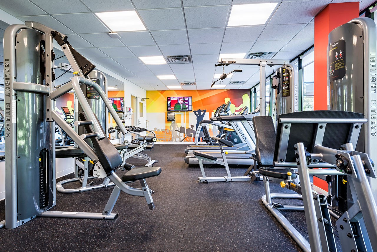 Modern fitness center with state-of-the-art equipment at Campus West Apartments, ideal for active lifestyles