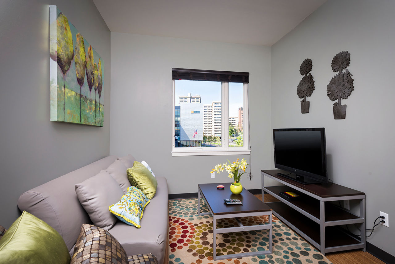 Spacious living room with modern furnishings at Campus West Apartments, offering luxury living for residents