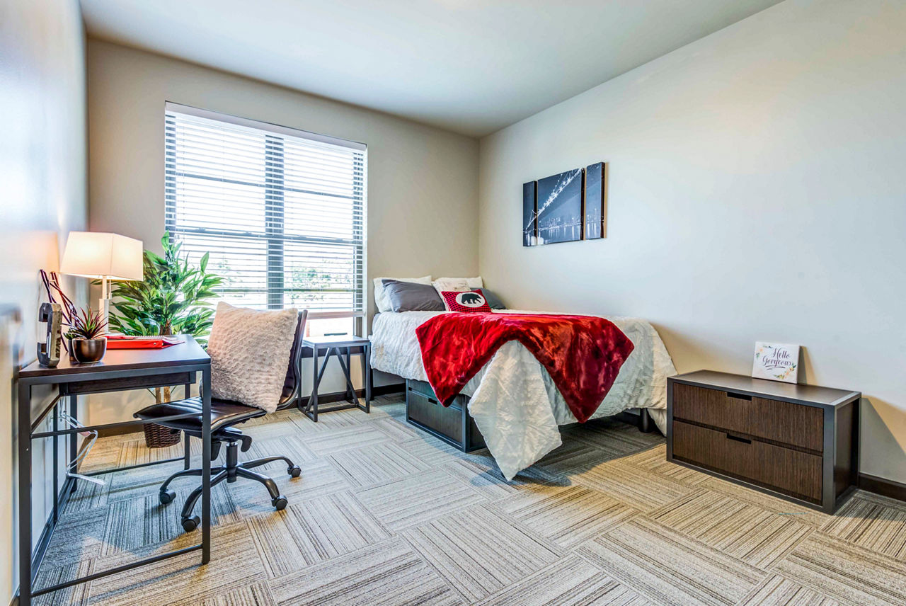 Cozy bedroom with modern furnishings at Maplewood Apartments