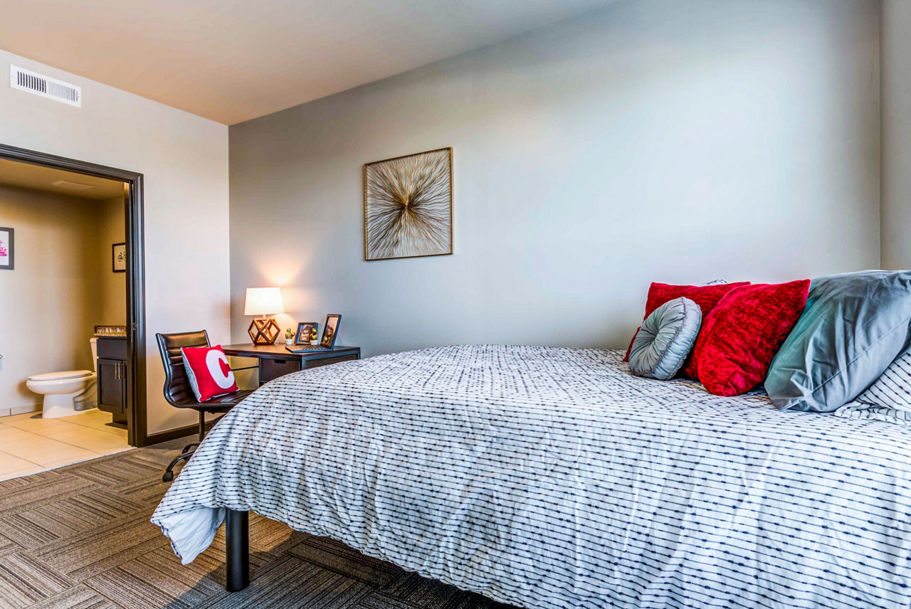 Cozy bedroom featuring natural light and modern decor at Maplewood Apartments