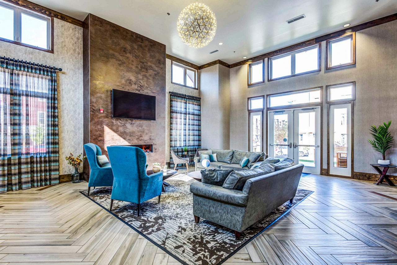 Clubhouse featuring modern design and comfortable seating at Maplewood Apartments, a luxury community by Greystar