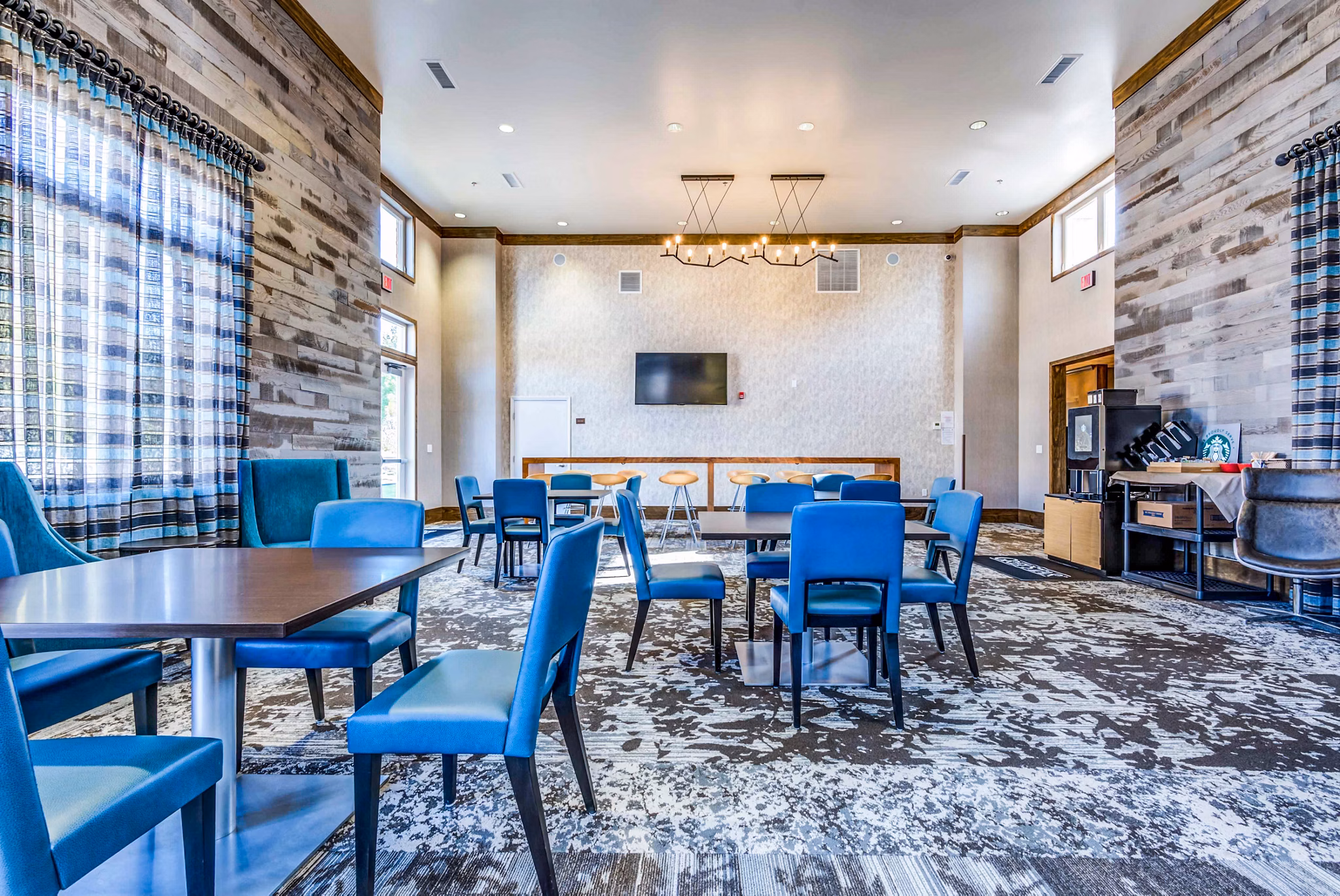 Modern clubhouse with cozy seating and billiards table at Maplewood Apartments