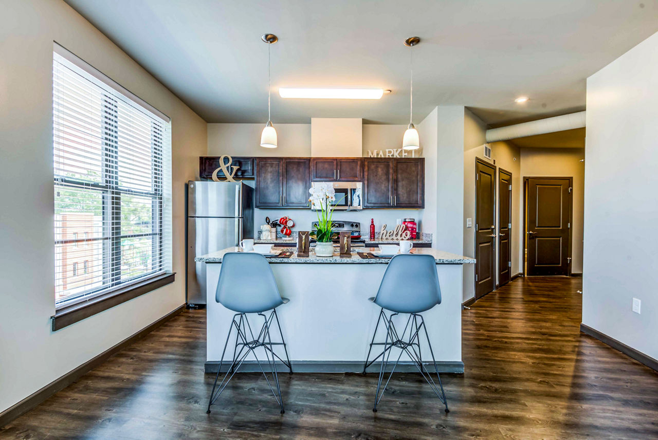 Modern kitchen with stainless steel appliances at Maplewood Apartments