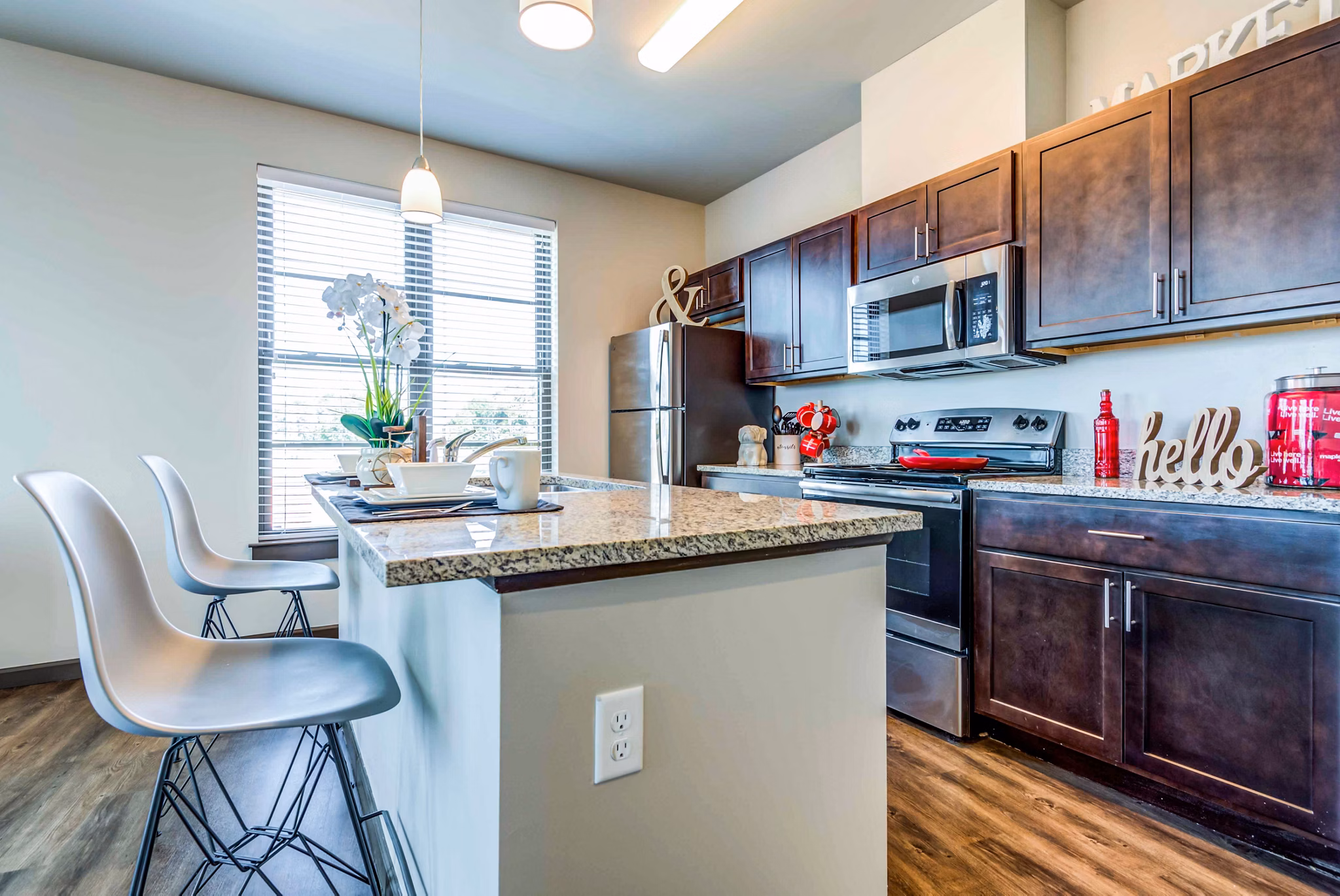 Modern kitchen featuring stainless steel appliances in Maplewood Apartments
