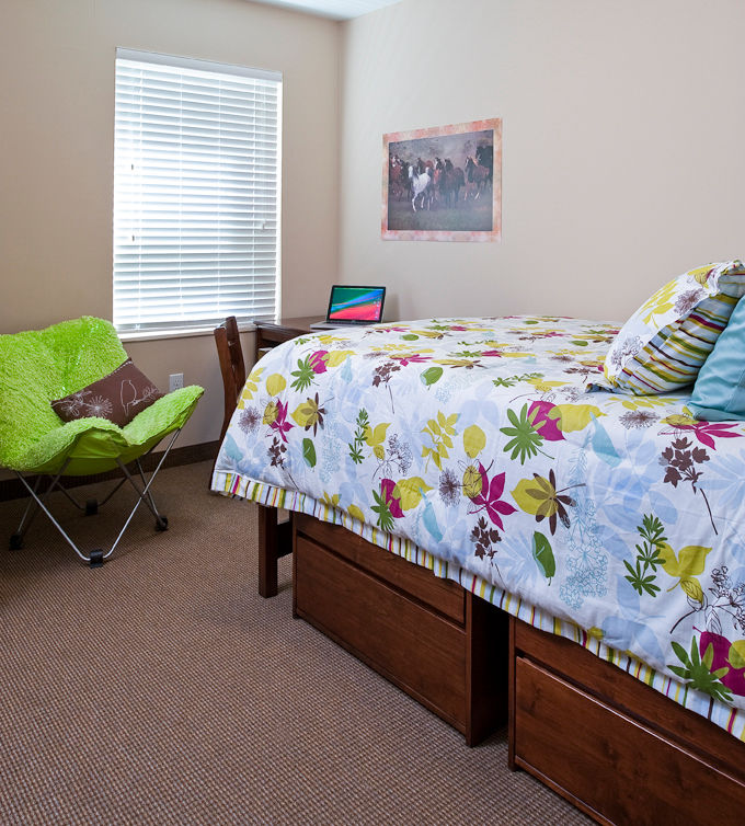 Cozy bedroom with modern furnishings at Centennial Hall Apartments