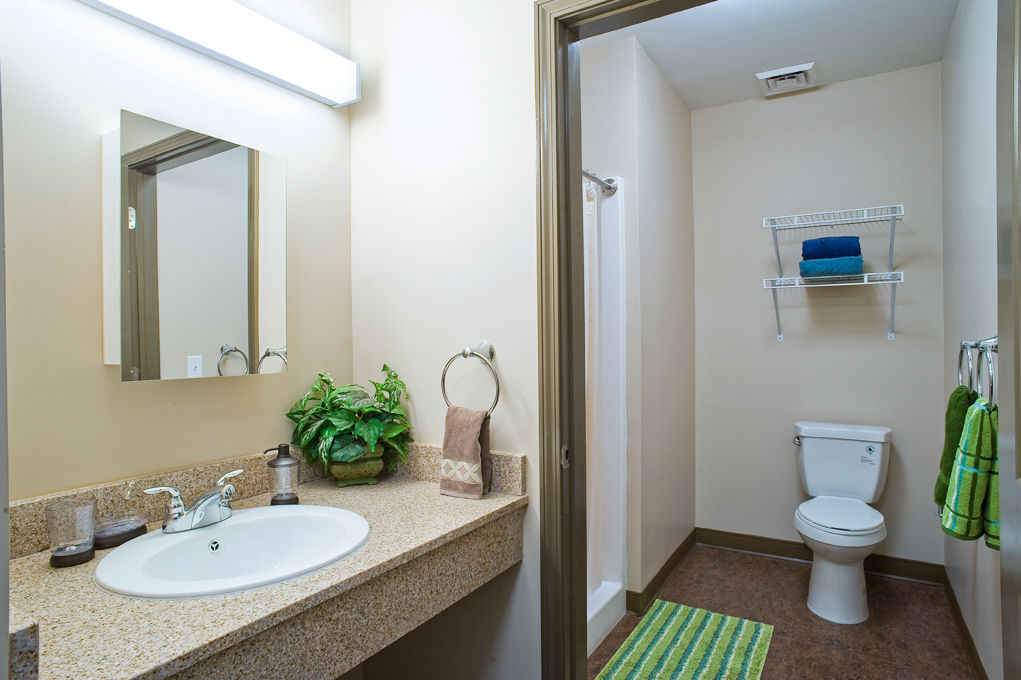 Bathroom with sleek fixtures and marble countertops in Centennial Hall Apartments