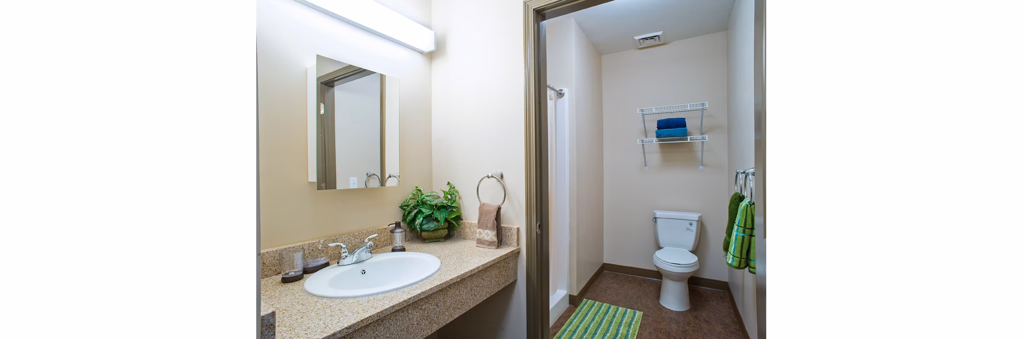 Bathroom with sleek fixtures and marble countertops in Centennial Hall Apartments