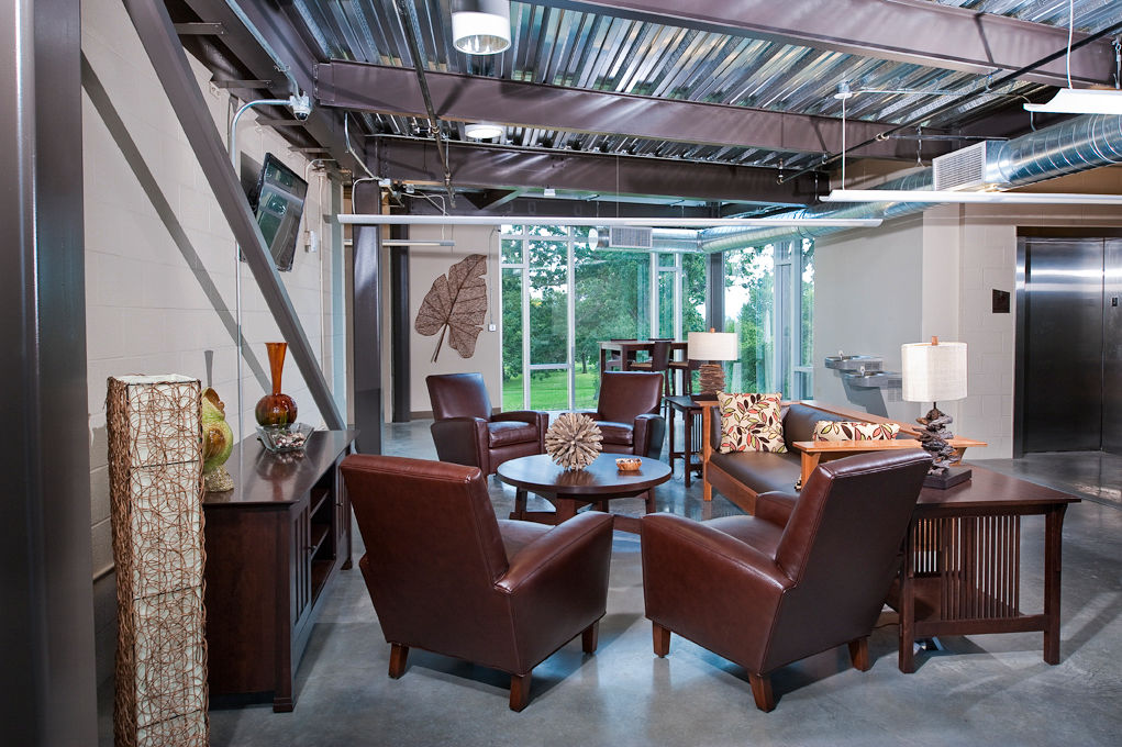 Modern clubhouse lounge with cozy seating and pool table at Centennial Hall Apartments, a luxury apartment community