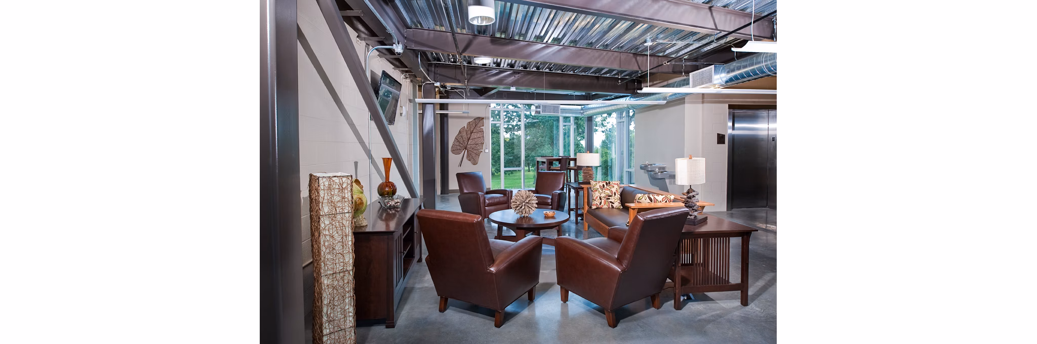 Modern clubhouse lounge with cozy seating and pool table at Centennial Hall Apartments, a luxury apartment community