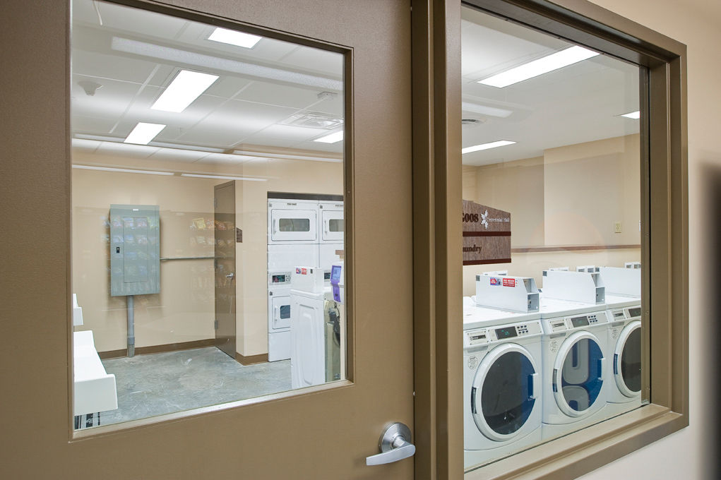 Modern laundry facility with energy-efficient machines at Centennial Hall Apartments