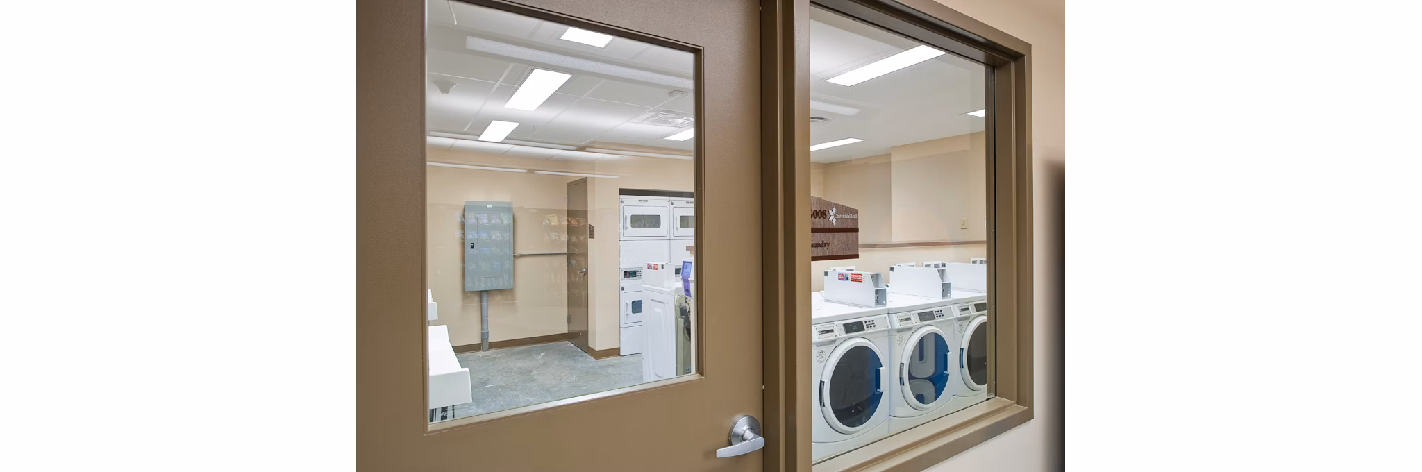 Modern laundry facility with energy-efficient machines at Centennial Hall Apartments