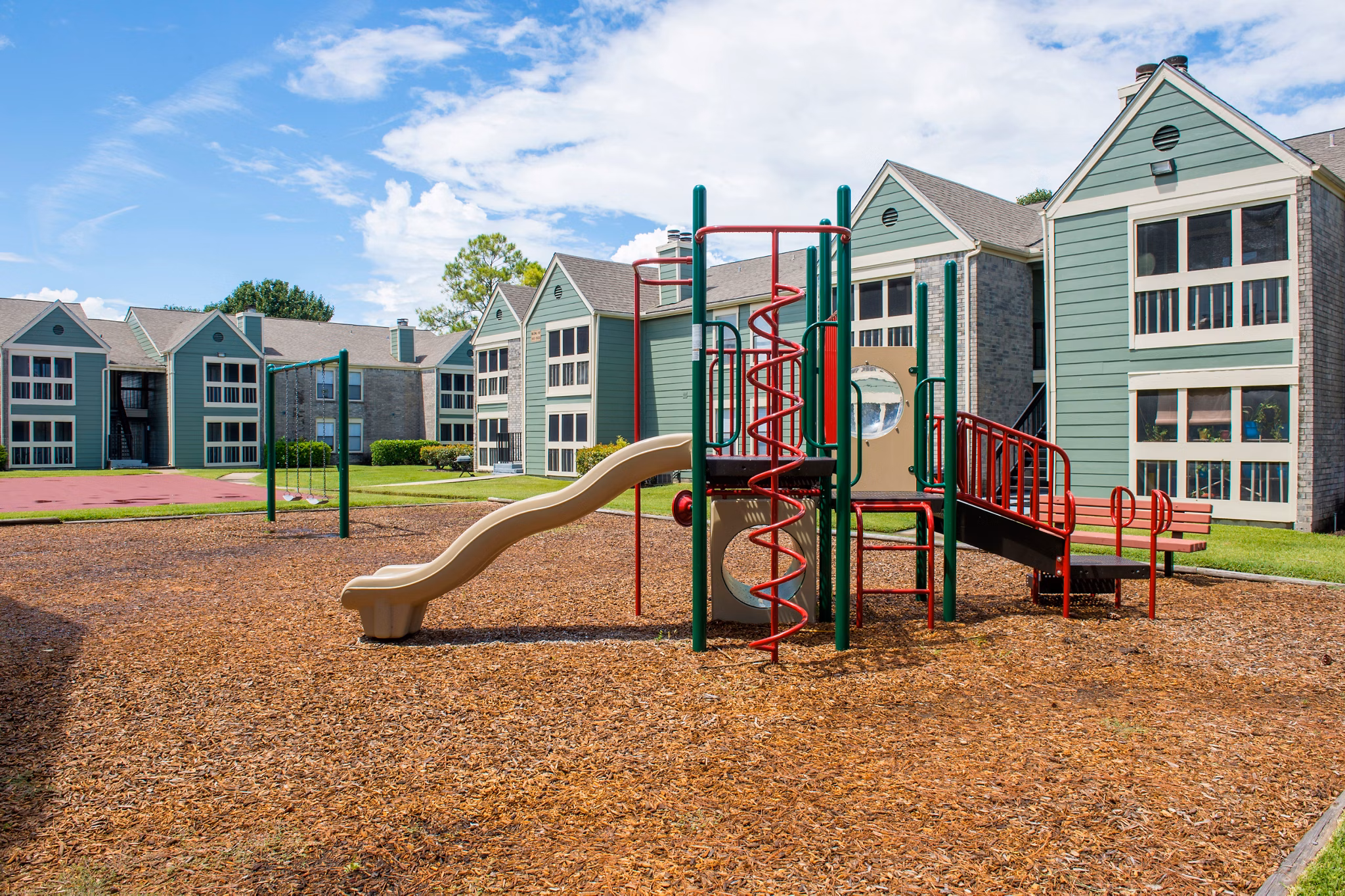 Playground with modern equipment at Willow Springs Apartments, a family-friendly feature for residents to enjoy outdoor activities