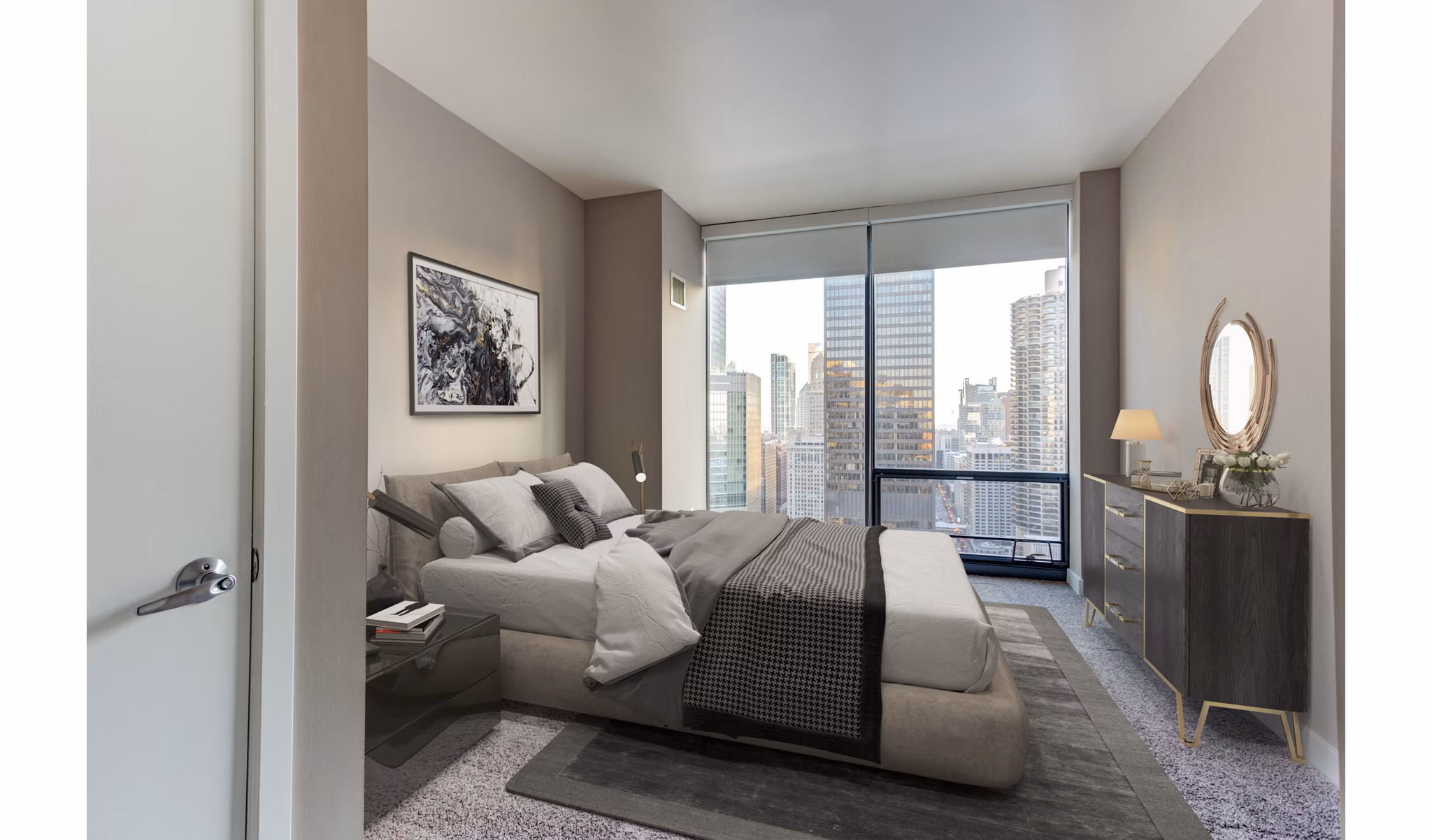 Cozy bedroom with plush bedding and city view at State & Grand Apartments, luxury living experience in Chicago's vibrant River North neighborhood