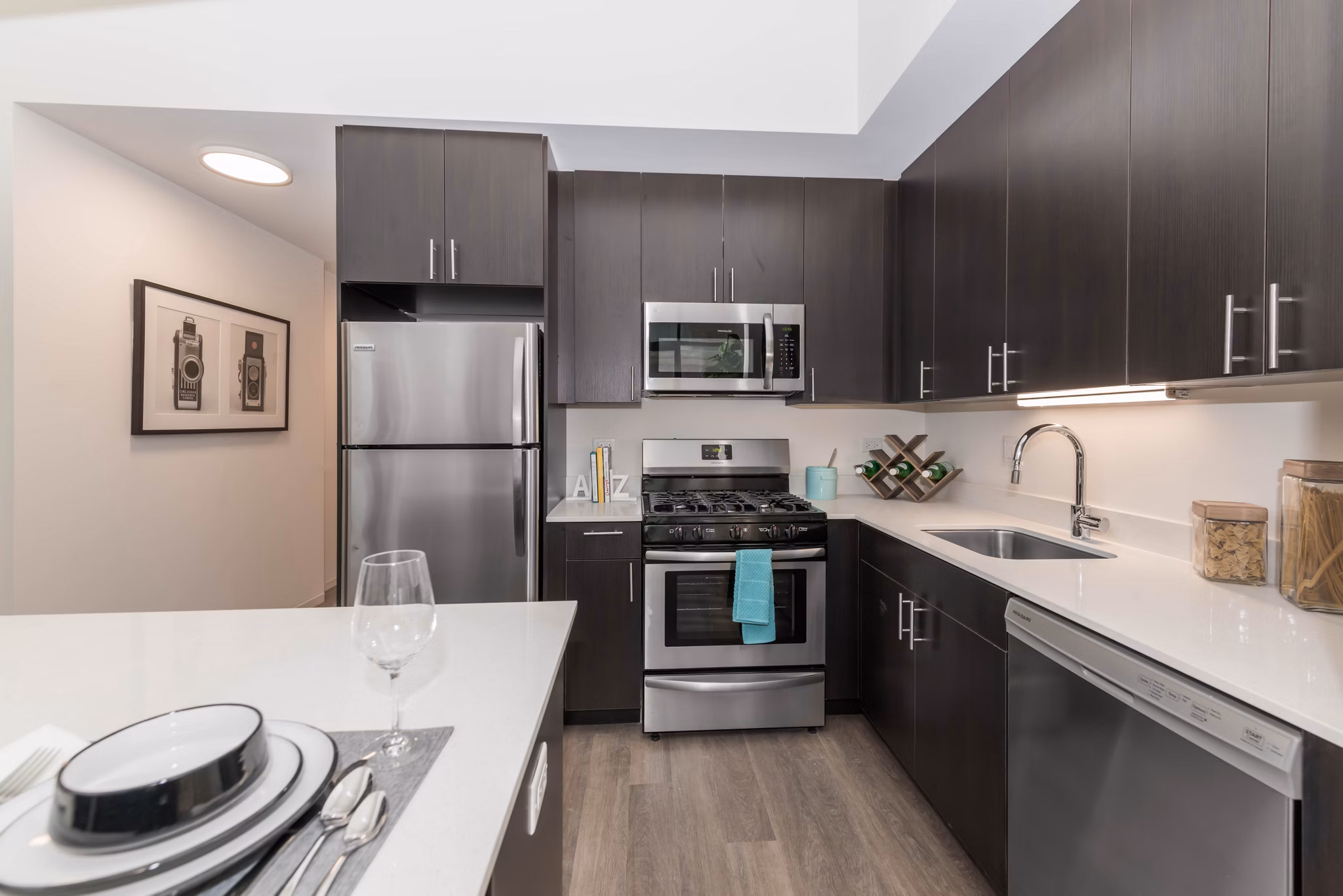 Modern kitchen with sleek countertops and stainless steel appliances at Coeval Apartments, luxury living in the heart of the city