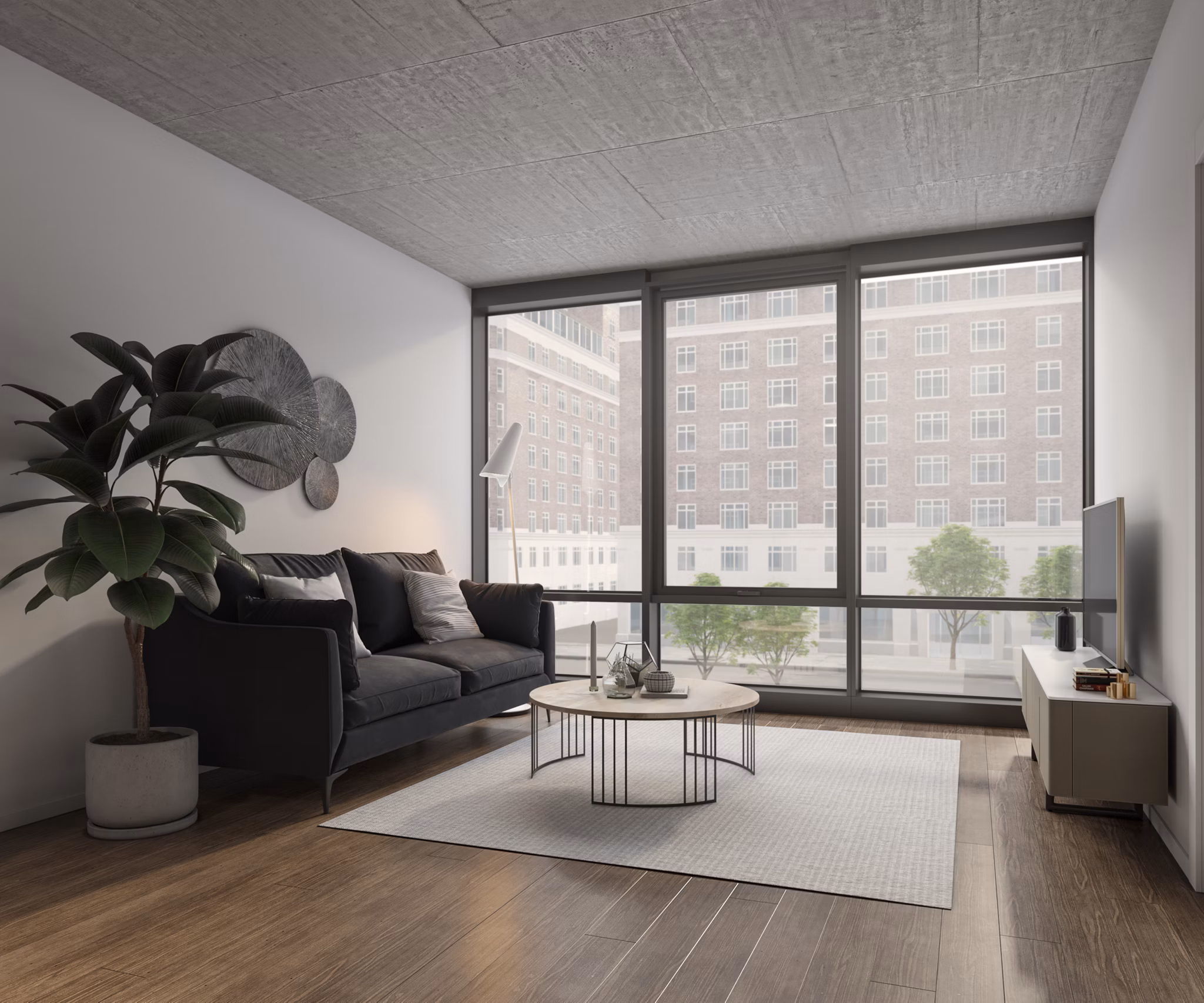 Living room with modern decor, large windows, and open layout in Coeval Apartments