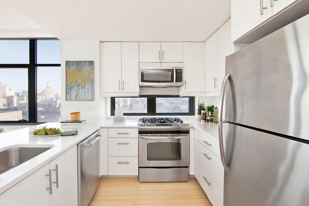 Contemporary kitchen with stainless steel appliances at 424 Bedford luxury apartments