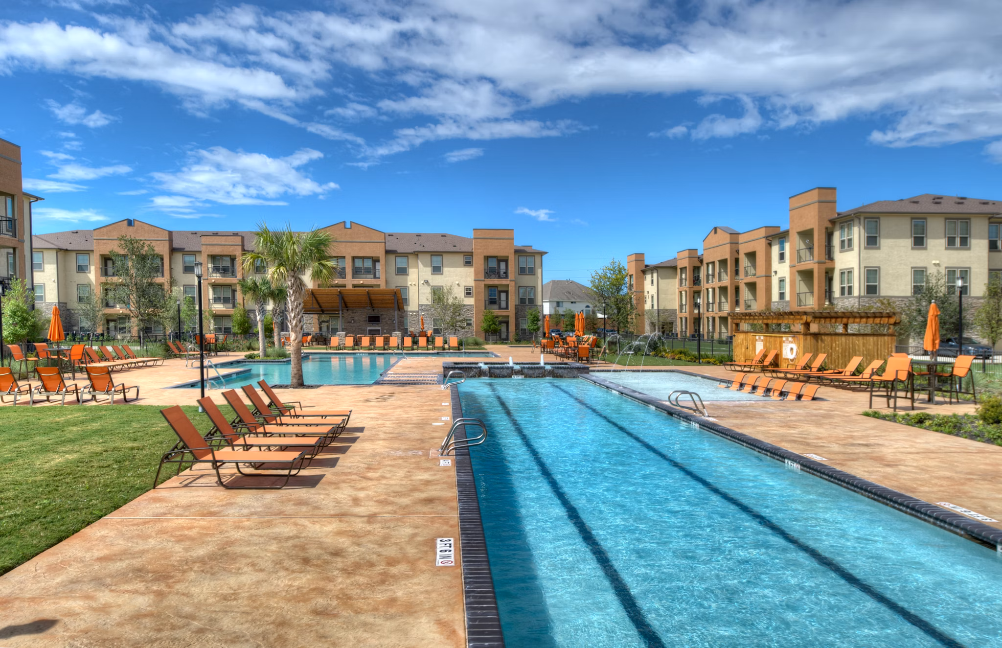 Resort-style pool with sun loungers at Retreat at Shadow Creek Ranch luxury apartments