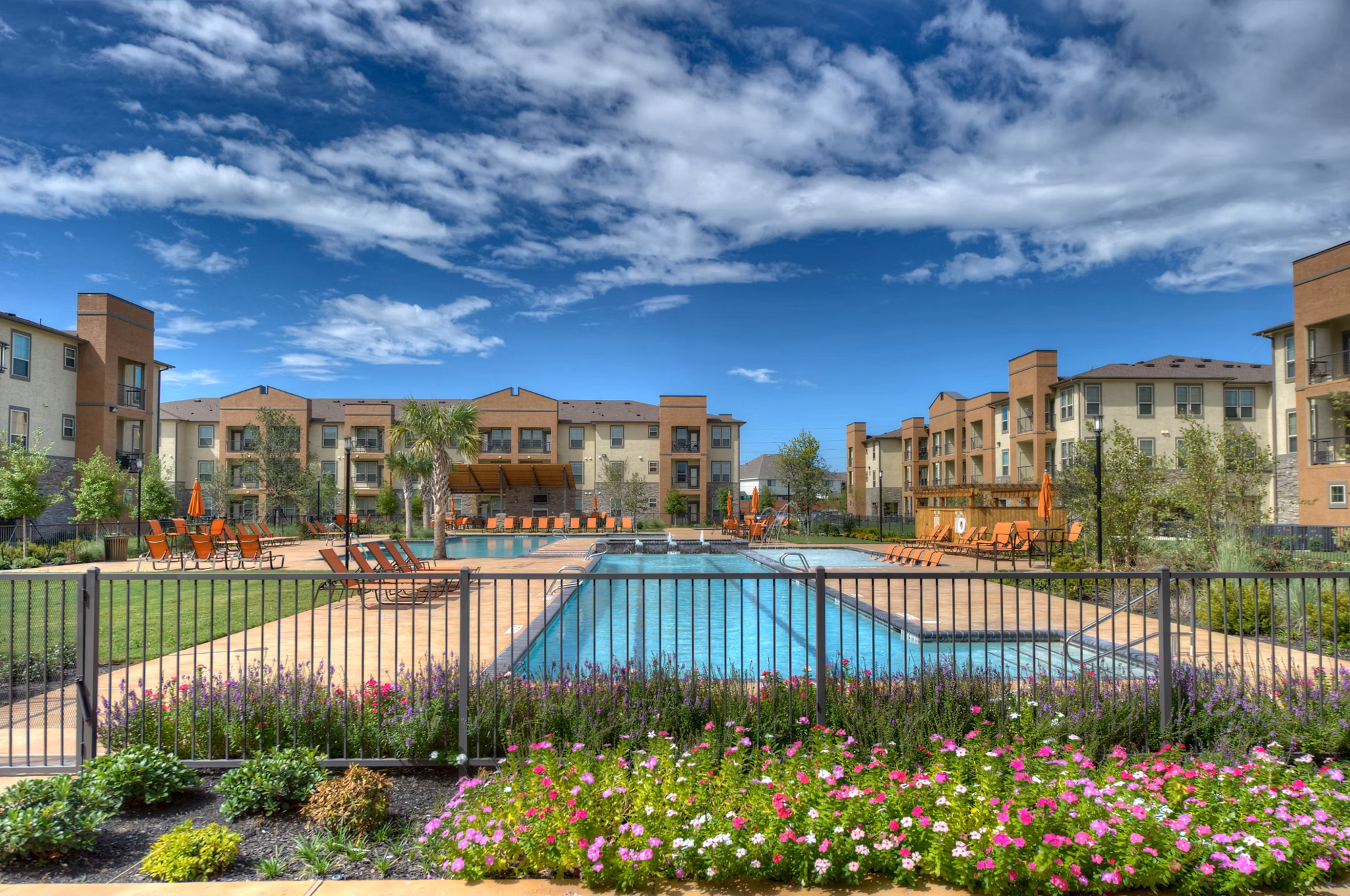 Serene outdoor pool with sun loungers at Retreat at Shadow Creek Ranch luxury apartments