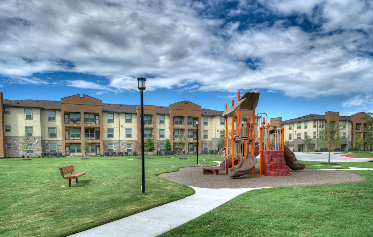 Children's playground with slides and swings at Retreat at Shadow Creek Ranch, offering family-friendly amenities in Texas
