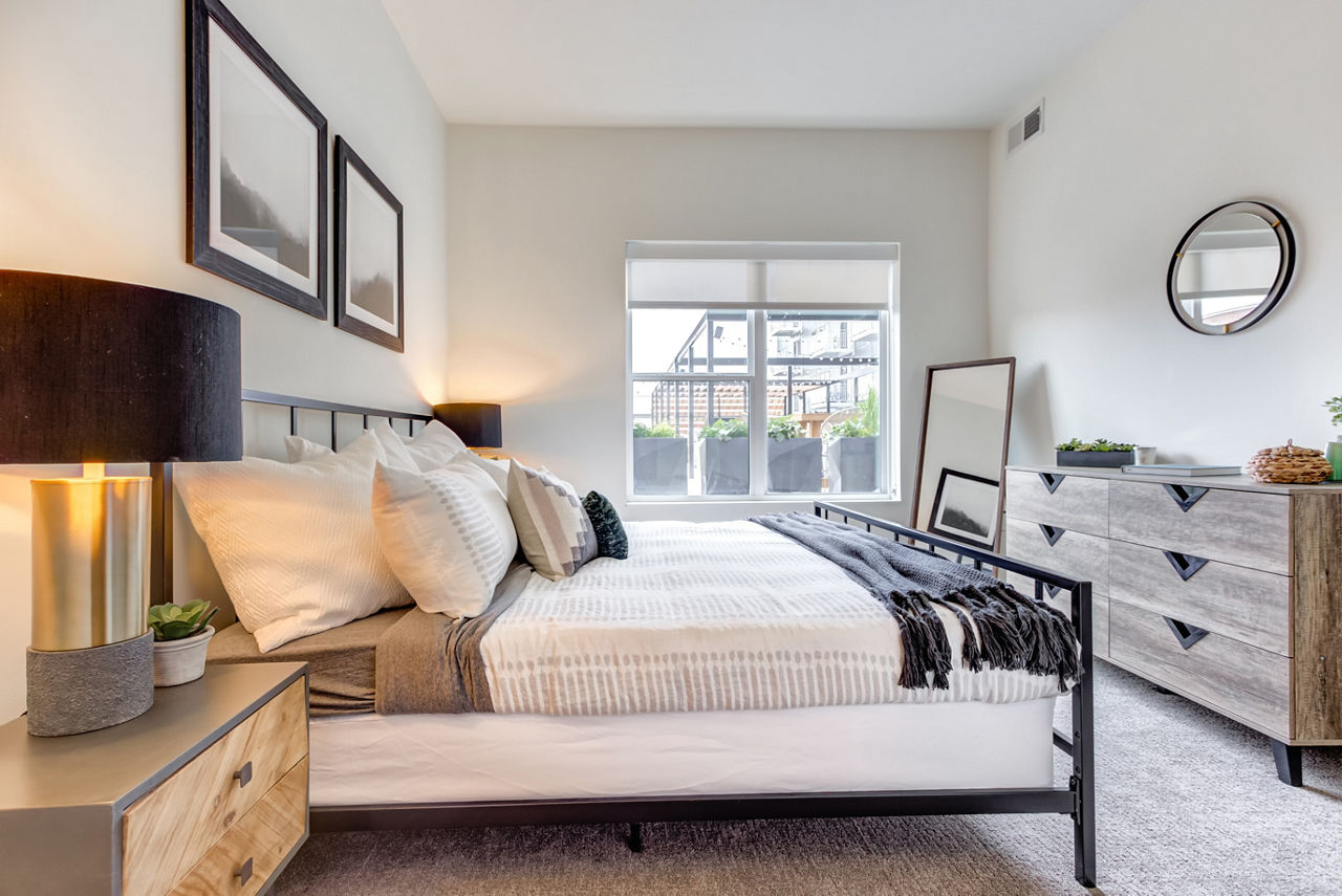 Cozy bedroom with stylish decor at The Marke of Elmhurst Apartments