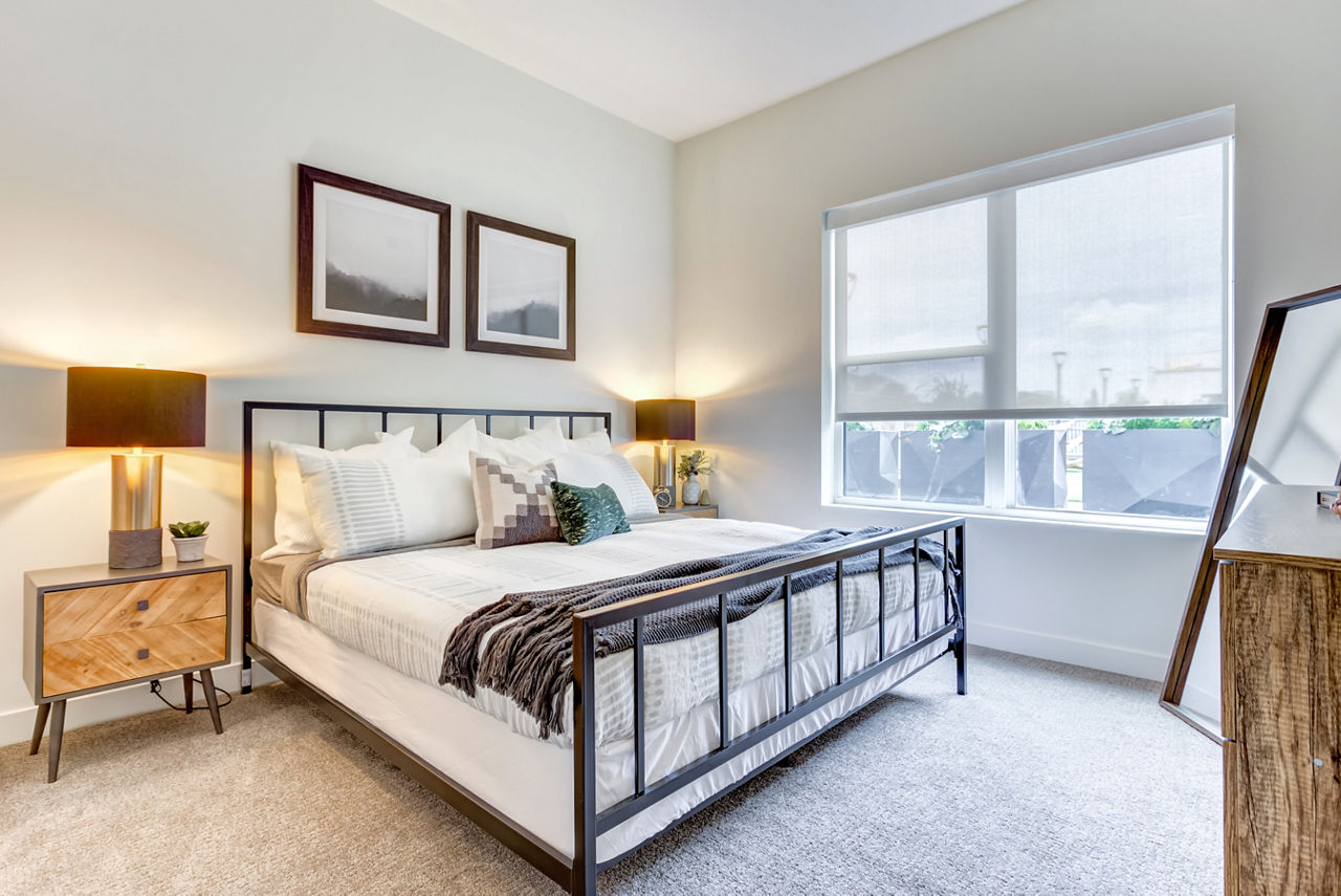 Cozy bedroom with contemporary furnishings at The Marke of Elmhurst Apartments