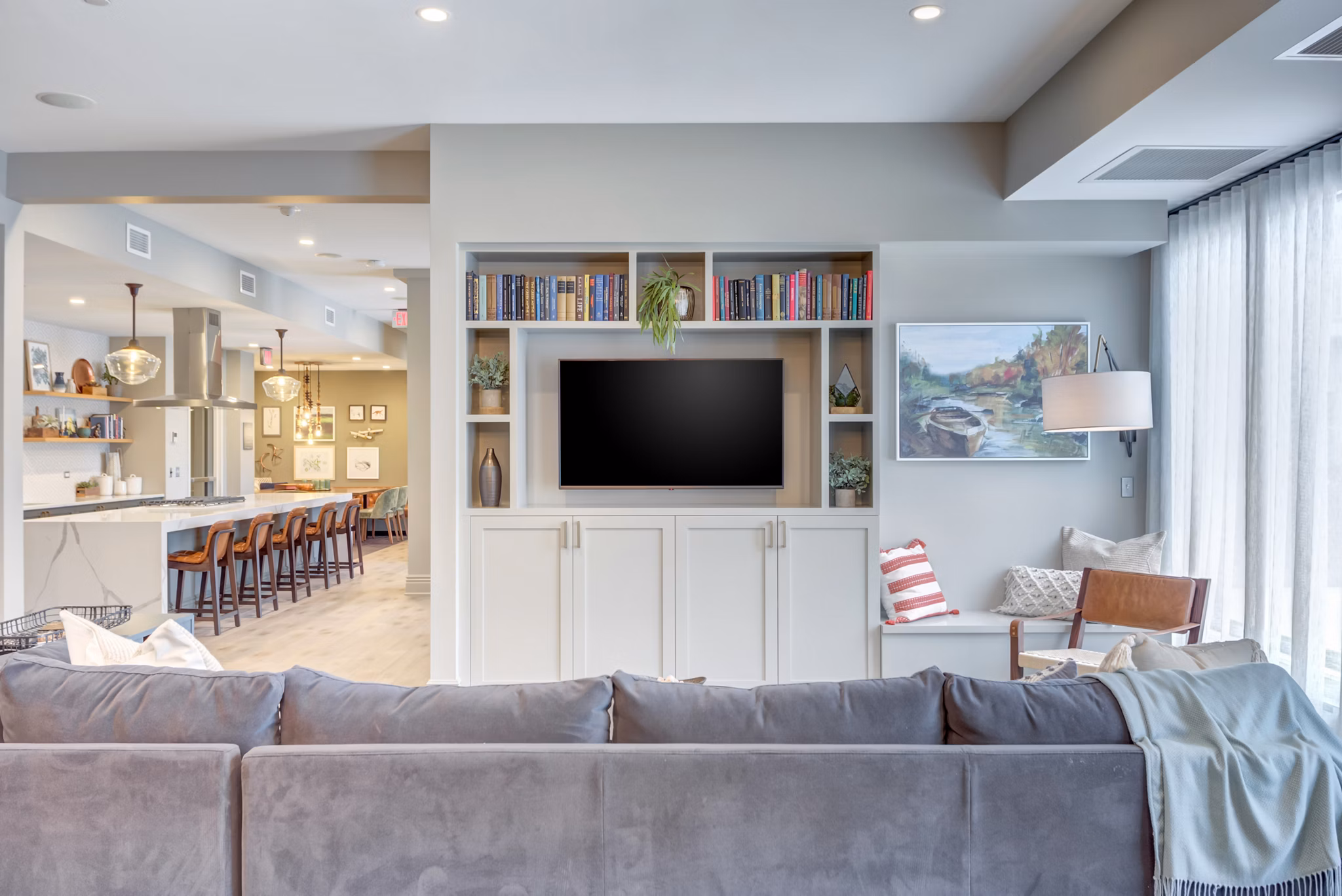 The Marke of Elmhurst: Elegant clubhouse with modern furnishings and ample seating, perfect for social gatherings at luxury apartments
