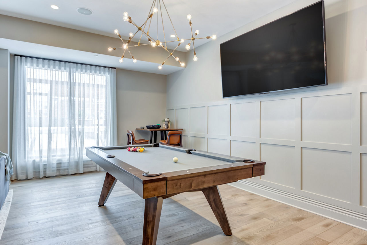 Game room with pool table and lounge seating at The Marke of Elmhurst Apartments, offering luxury living and recreational amenities